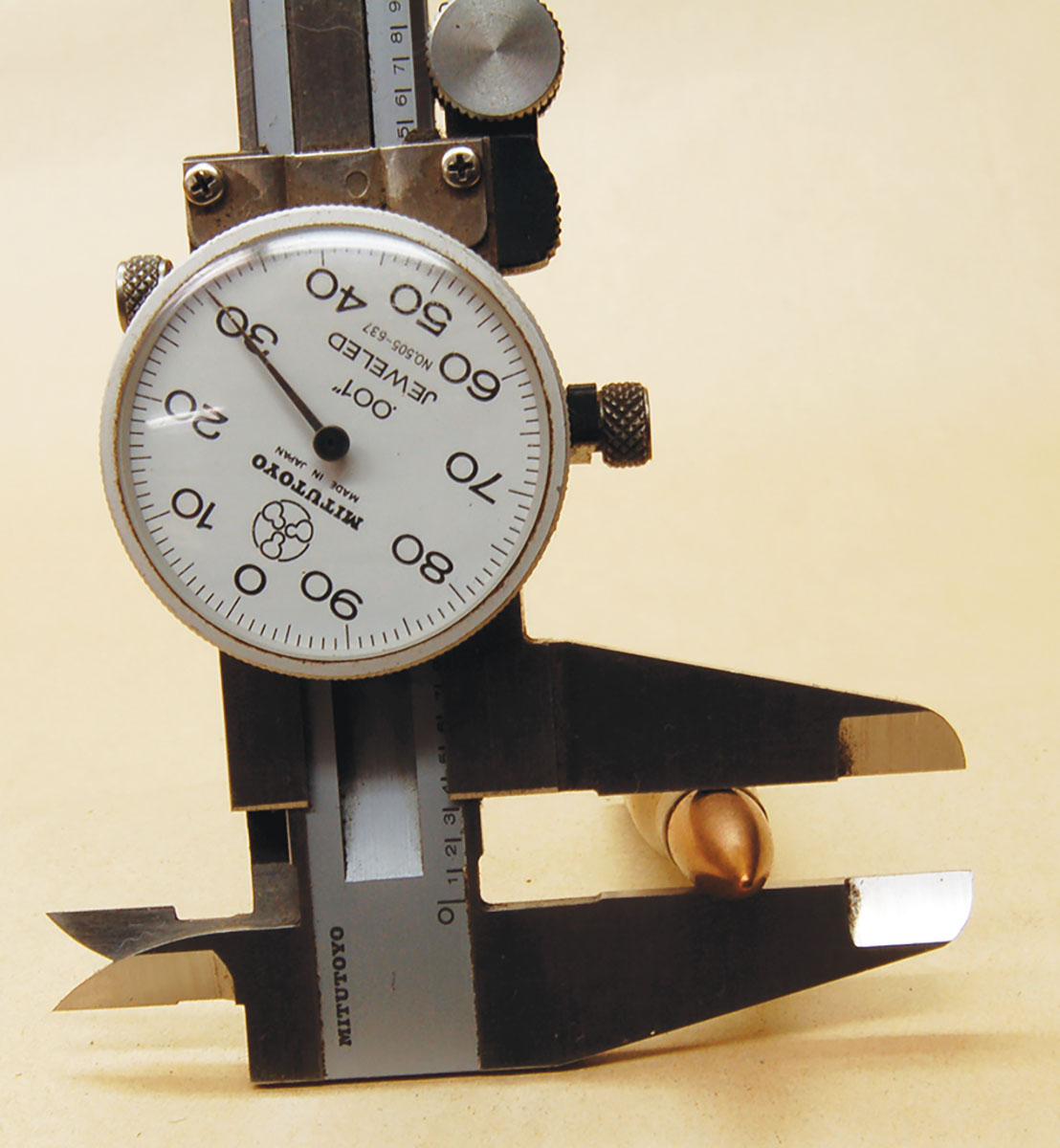 The caliper on the bullet of an 8x56mmR showing .330-inch diameter, not .323 inch of the 8x50mmR.